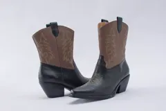 Bota texana de cuero negro con bordados en el lateral y taco bajo.