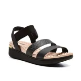 Sandalias negras con plataforma baja, tiras anchas y elásticas.