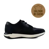 Zapato de vestir acordonado color negro, de cuero, con suela blanca y detalles en gamuza.