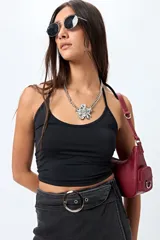 Short pollera de denim azul con spandex, corte mini y diseño cruzado al frente. Incluye cinturón integrado con hebilla metálica redonda.