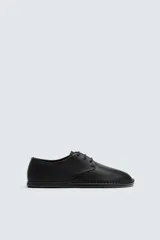 Zapato de cordones tipo derby, color negro, con capellada de cuero abatanado, plantilla de cuero y suela ultrafina.