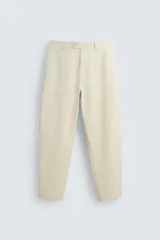 Pantalón chino color beige, corte recto, con bolsillos laterales y traseros. Cierre frontal con cremallera y botón.
