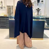 Poncho de lanilla en color negro, diseño oversize y sin cierre.