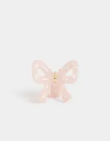 Broche para el pelo color rosa claro con forma de moño y lazo.