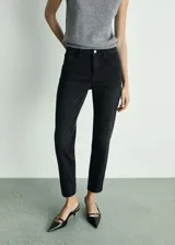 Pantalón de jean negro de corte recto, tiro alto y largo al tobillo.