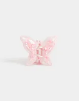 Broche para el pelo color rosa pastel con forma de mariposa y detalle de confetti.