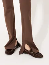 Pantalón negro de punto liso, con cintura elastizada y tajos laterales en el ruedo.