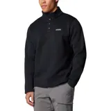 Chaqueta de forro polar Columbia, color negro, con cuello alto y cierre frontal de tres botones. Presenta un panel horizontal en el pecho y el logo de la marca bordado en el lado izquierdo del pecho.