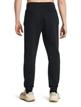 Pantalón de jogging Under Armour color beige, de corte holgado, con cintura elástica ajustable con cordón y puños acanalados.