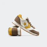 Championes Converse Omega Trainer Lux, inspirados en el running de los 80, color blanco con detalles en marrón, amarillo y suela caramelo.