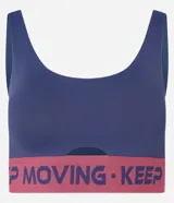 Top deportivo negro de microfibra con breteles anchos, copas desmontables, recorte cut-out en el busto y banda elástica con estampado de letras "Keep Moving".