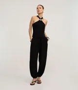 Pantalón de mujer estilo balloon (o slouchy) color negro, confeccionado en viscosa y poliéster. Presenta cintura elástica y puños elásticos en los tobillos.