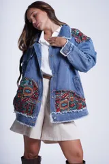 Campera de jean celeste con apliques de patchwork con motivos geométricos en hombros y bolsillos.