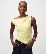 Blusa sin mangas color amarillo claro, confeccionada en microfibra, con escote asimétrico de un solo hombro, detalle torcido en el hombro y fruncidos en el cuerpo. Presenta un bajo asimétrico.