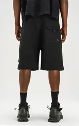 Bermuda negra de calce relax-fit, confeccionada en nylon y spandex, con tejido repelente al agua. Presenta cintura con elástico y cordón de ajuste, bolsillos delanteros con fuelle y grandes bolsillos cargo laterales con tapa. Incluye un cinturón de cinta ajustable con hebilla de plástico.