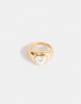 Anillo dorado con corazón de esmalte blanco.