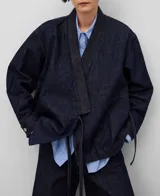 Chaqueta tipo kimono de denim de algodón color azul oscuro, con cuello kimono, cierre cruzado con lazos laterales, mangas amplias con puños y bajo recto.