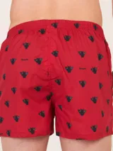 Bóxer de algodón blanco con estampado de flores pequeñas color celeste, con cintura elástica y logo de la marca en el centro.