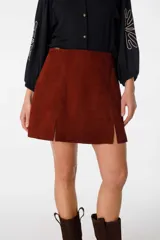 Minifalda marrón de cuero gamuzado, con corte en A y aberturas laterales.
