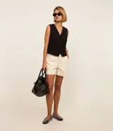 Short de cintura alta color beige, con bolsillos y costuras a la vista.