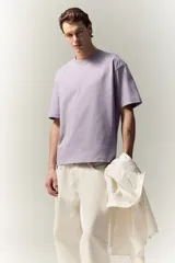 Remera lila de algodón pesado, corte holgado, con cuello redondo ribeteado y hombros caídos.
