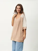 Remera color beige con escote en V y mangas cortas ranglán en color crema.