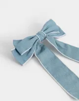 Hebilla francesa para el pelo con moño de denim celeste y borde blanco.