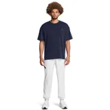 Pantalón deportivo Under Armour Unstoppable para hombre, color negro, de corte ajustado con puños elásticos en los tobillos y bolsillos laterales con cierre.