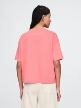 Remera corta color blanco con logo de Gap estampado en el frente y mangas cortas con detalle de rayas horizontales.