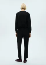 Sweater negro de tejido fluido con cuello redondo y mangas largas.