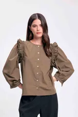 Blusa color verde militar con cuello redondo, abotonada al frente y mangas largas abullonadas con volados en los hombros.
