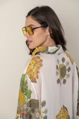 Camisa italiana de viscosa estampada con diseño abstracto en tonos azul, amarillo y verde sobre fondo natural, de corte irregular y mangas 3/4.