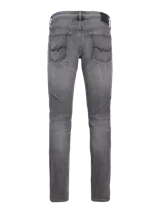 Jean de corte slim fit, color gris lavado, con tiro bajo, rodilla ajustada y pierna ceñida.