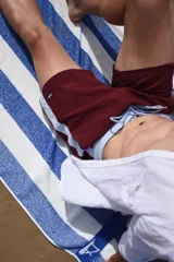 Short de baño color borgoña con cintura y laterales celestes.