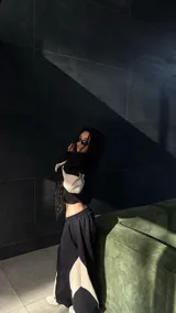 Conjunto deportivo negro con detalles en blanco, compuesto por un hoodie oversize con mangas largas y un pantalón baggy con paneles geométricos en contraste.