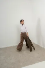 Pantalón marrón de tencel, corte ancho con pinzas y bolsillos laterales.