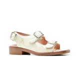 Sandalias bajas de cuero sintético color blanco hueso, con tres tiras horizontales con hebillas metálicas plateadas.