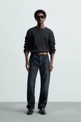 Camiseta blanca de manga larga con cuello redondo y textura cuadriculada.