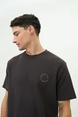 Remera gris oscuro con textura, cuello redondo y manga corta. Tiene un pequeño logo estampado en el pecho.