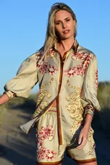 Camisa de seda beige con estampado de flores y tigres, con detalles en solapa y mangas abullonadas.