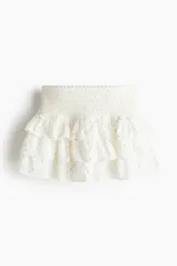 Minifalda blanca con lunares dorados, cintura elastizada y tres niveles de volados.