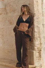 Pantalón marrón de corte ancho, con cintura elástica y bolsillos laterales.