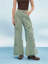 Pantalón jean de tiro alto color verde oliva, corte acampanado y detalles rotos con flecos.