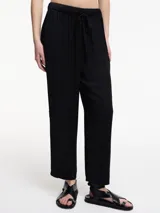 Pantalón negro de corte recto con pretina ajustable mediante lazo.