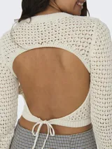 Sweater corto color crema, tejido a crochet con cuello redondo y mangas largas.