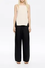 Pantalón de corte recto en mezcla de lino, largo tobillero, con cierre de botonadura frontal y bolsillos con vivo. Presenta pinzas en delantero y cintura elástica en espalda.