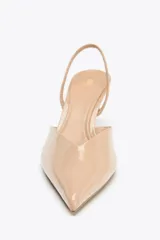 Zapato destalonado color beige acharolado, con escote en pico, tira trasera ajustable y tacón fino.