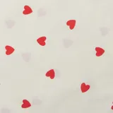 Tote bag de tela color crudo con estampado de corazones rojos.