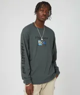 Remera de manga larga Carhartt WIP color gris con estampado frontal de un personaje viendo televisión y logo de la marca en la manga izquierda.