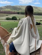 Capa color crema de tejido fino en lana merino con detalles en cuero.